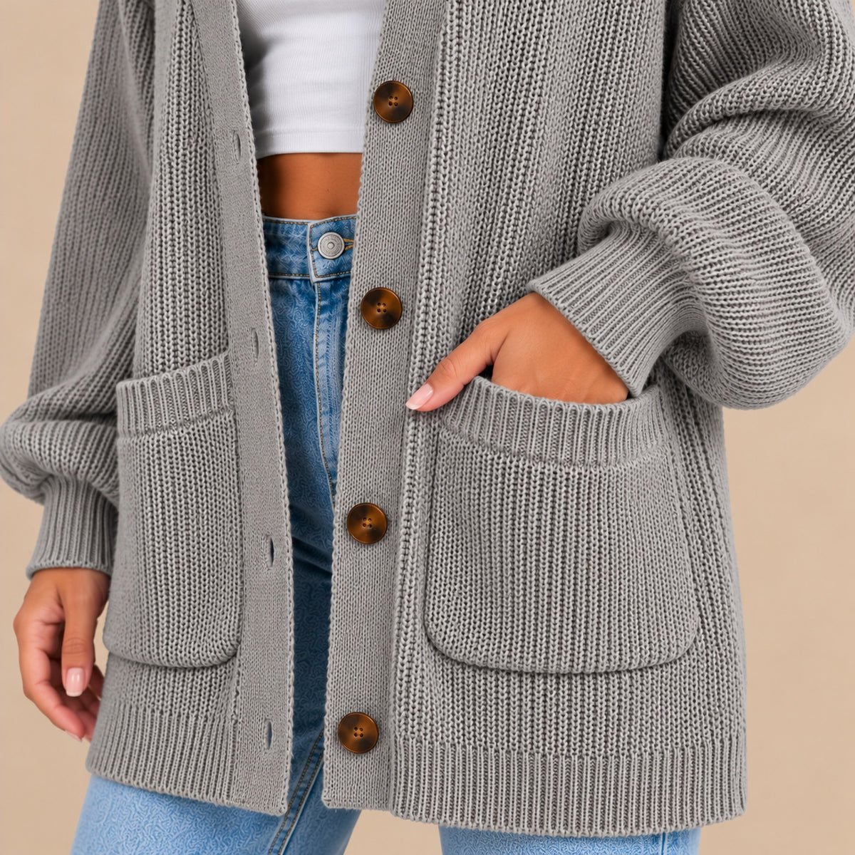 Women's oversized textured knit cardigan in grey – button placket and patch pocket close-up