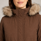 Women's loose-fit padded parka with faux fur trim hood in brown – detail close-up