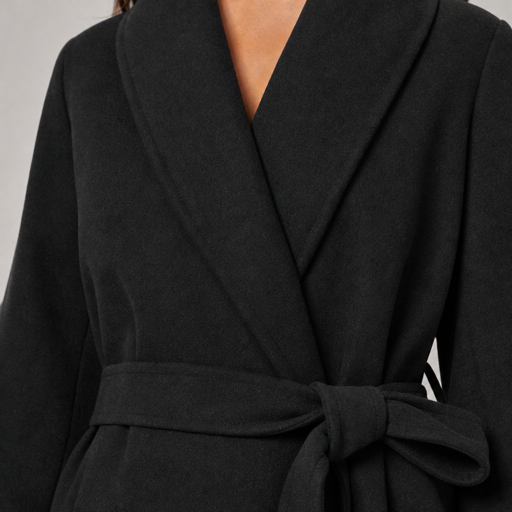 Women's relaxed-fit belted wrap coat with shawl collar and faux fur cuffs in black – detail close-up